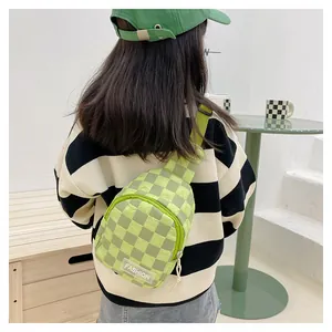 Detail of green checkerboard kids chest bag with quilted texture and fashion logo