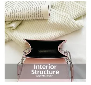 Internal structure of small pink PU handbag with silver D-rings and black lining details