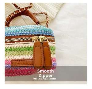 Close-up of the smooth golden two-way zipper and colorful woven pattern of the mini bag