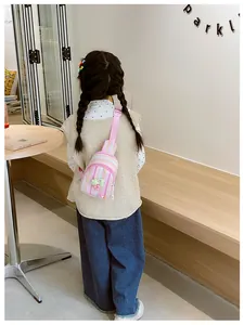 Detailed close-up of a pink striped canvas chest bag for girls with cherry charm