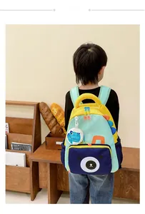 Detail of cute dinosaur backpack with 3D scales and small bear print pocket for kids