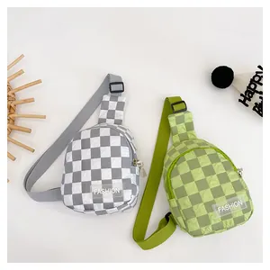 Detail of checkerboard pattern kids chest bags in grey and green with fashion label