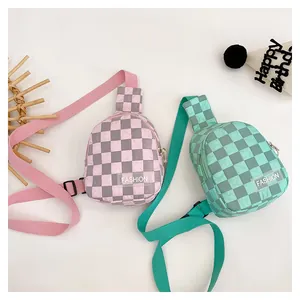 Detail of green and pink checkerboard chest bags for kids with adjustable nylon straps