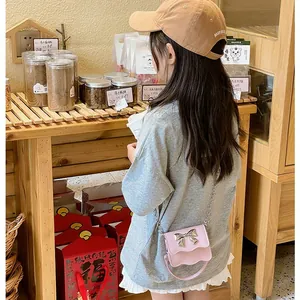 Pink mini PU crossbody bag for girls with metal bow detail and chain strap