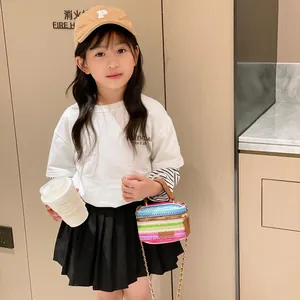 Children's woven chain crossbody bag with bow, styled with casual outfits