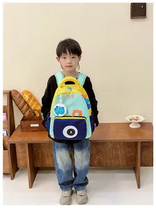 Detail of color-block kids dinosaur backpack with cartoon bear and dinosaur back spines