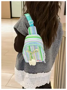 Detail view of colorful striped kids chest bag with tulip charm on a girl's back