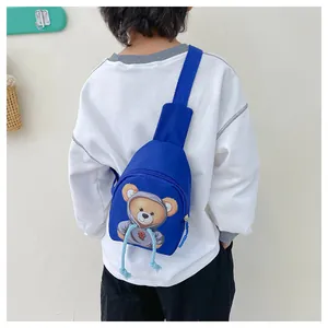 Blue kids crossbody chest bag with cartoon bear print worn over the shoulder
