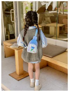 Detailed outdoor shot of a child wearing a striped tulip crossbody bag on a wooden bench