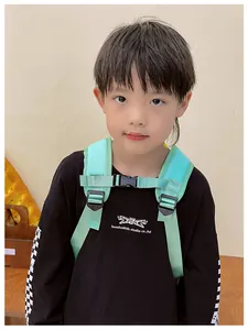 Close-up of mint green nylon shoulder straps with adjustable buckle on a child's backpack