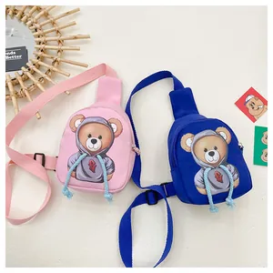 Detail showing pink and blue cartoon bear crossbody bags with adjustable nylon straps