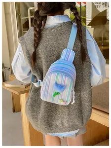Detail of blue striped crossbody bag with tulip flower and LOVE lettering on a girl