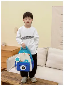 Close-up of blue bear-shaped front pocket and durable nylon texture of kids backpack