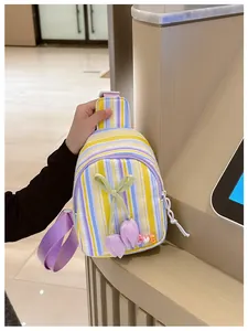 Detail of colorful striped canvas kids chest bag with tulip charms and LOVE lettering