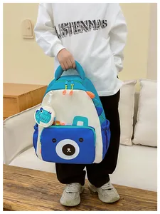 Blue cartoon bear backpack detail with cute 3D ears and dinosaur coin purse accessory