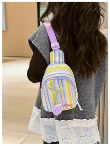 Detail view of colorful striped kids crossbody bag with tulip flower and LOVE charm