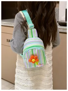 Rear view of a girl wearing a colorful striped crossbody bag with 3D flower and LOVE beads