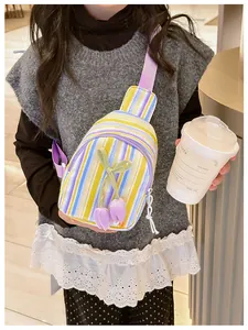 Detail of colorful striped crossbody bag with 3D tulip flower and purple strap