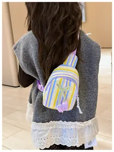 Detail of colorful striped kid chest bag with purple tulip decoration on little girl