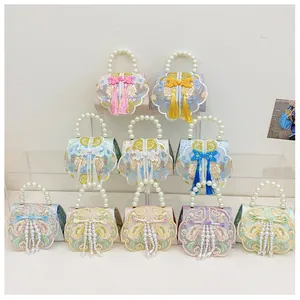 Detailed view of ten colorful traditional Chinese embroidery handbags with pearl handles