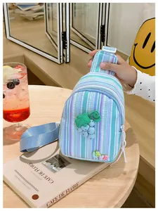 Close-up of striped canvas kids chest bag with grape pendant and 3D LOVE letters