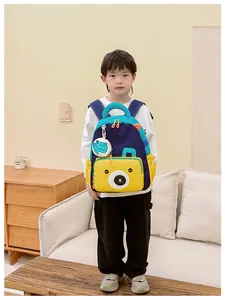 Detail of color-block kids backpack with cute cartoon bear face and side storage pocket