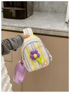 Detail view of striped crossbody bag for girls with purple flower and LOVE beads charm