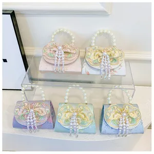 Detail of five vintage pearl handbags with floral jacquard and lace embroidery tassels