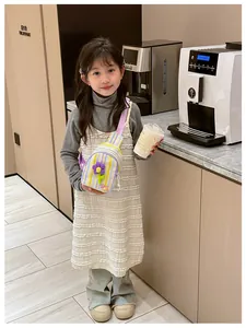 Little girl wearing a colorful striped crossbody bag with a purple 3D flower decoration