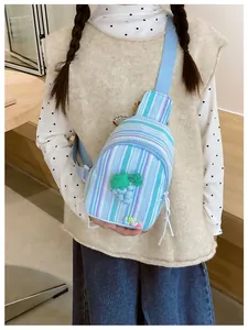 Detail of blue striped girls crossbody bag with cute purple grape 3D ornament