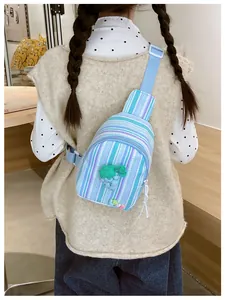 Detail of girls striped crossbody chest bag with grape decor and adjustable strap