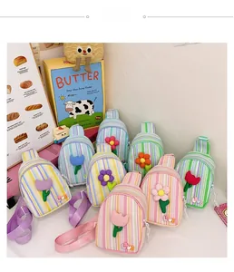 Detailed view of colorful striped crossbody chest bags with 3D flower patches for girls