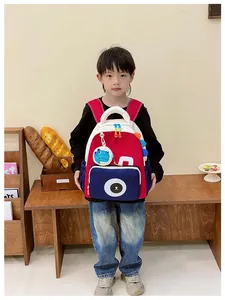 Detail of red and blue color-block kids backpack featuring a cute cartoon bear face