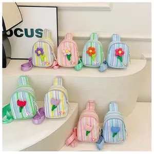 Detail shot of mini candy-colored striped crossbody bags for girls with floral accents
