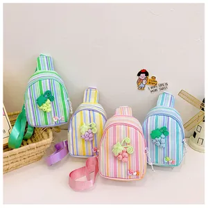 Detail of colorful striped mini chest bags for girls featuring 3D grape charms