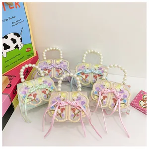 Detail of embroidered floral patterns with traditional Chinese knots and pearl handles on bags