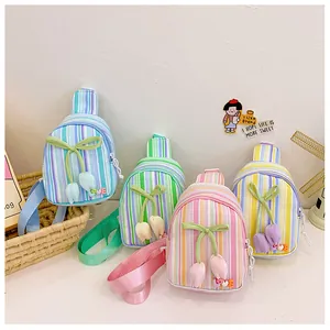 Detail of sweet striped kids cross-body bags with bow and tulip charms in macaron colors