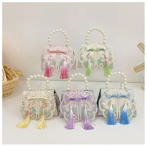 Detailed set of five traditional Chinese mini handbags with floral embroidery and pearls
