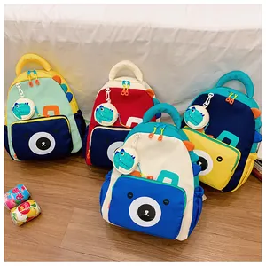 Detail of colorful nylon kids backpacks with dinosaur fins and bear print in four colors
