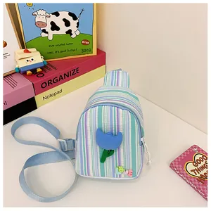 Detail of colorful striped crossbody bag for girls with 3D tulip and Love letter charms