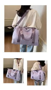 Detail of lavender purple bubble texture travel bag with adjustable strap and logo