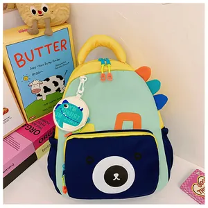 Detail of dinosaur fin decor and round bear mini pouch on children's colorful backpack