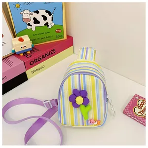 Detailed view of striped crossbody bag with 3D flower decoration and adjustable strap