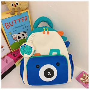 Detail of dinosaur kids backpack with cartoon bear face and colorful dinosaur fins