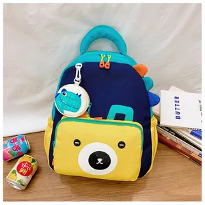 Detail of multi-color kids backpack with bear face pocket and dinosaur fin decor