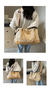 Detail of large canvas tote bag with leather trim, NINGRUA logo, and adjustable strap