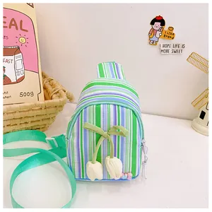 Close-up of colorful striped children chest bag with tulip charm and bow detail