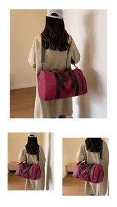 Close-up of large burgundy travel bag with side zipper pocket and sturdy black straps