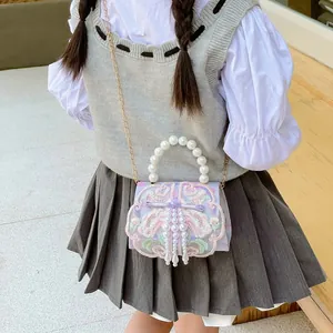 Girl's purple crossbody bag with floral embroidery, pearl handle, and metal chain strap