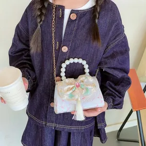Kids pearl handbag with embroidered bow, tassel detail and golden chain strap